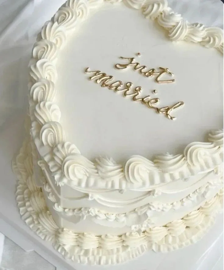 White frosted cake with piped icing borders and 